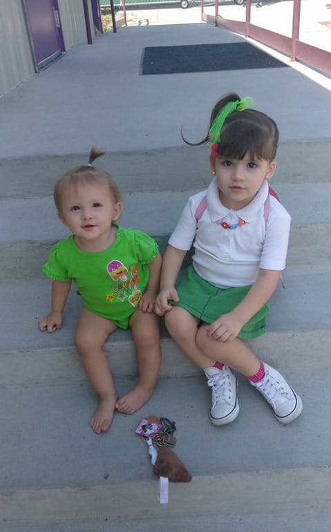 Two children sitting on concrete steps