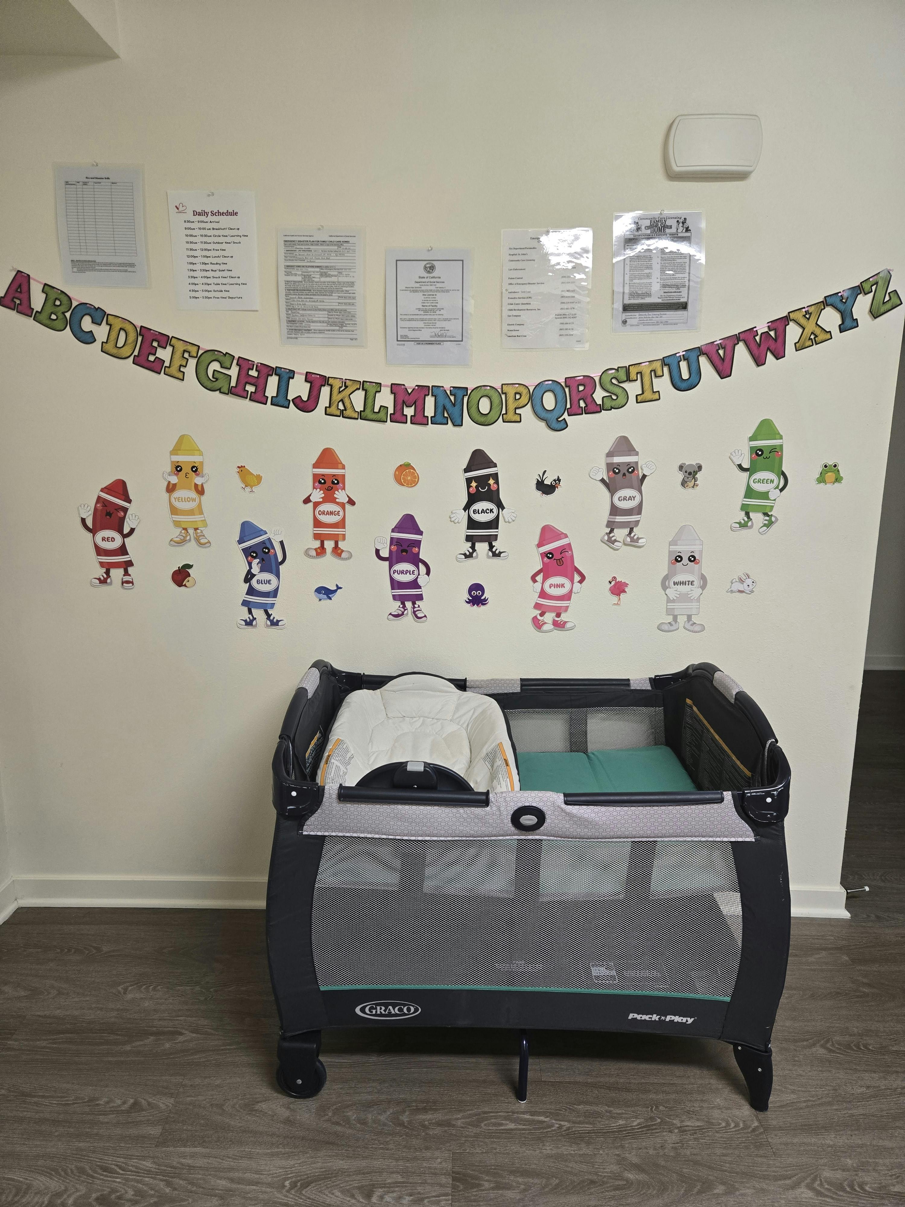 Playard with a changing station and wall decorations including an alphabet banner