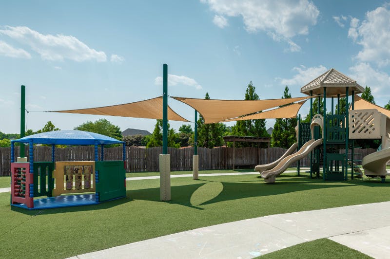 Playground with slides, climbing structures, and shade sails