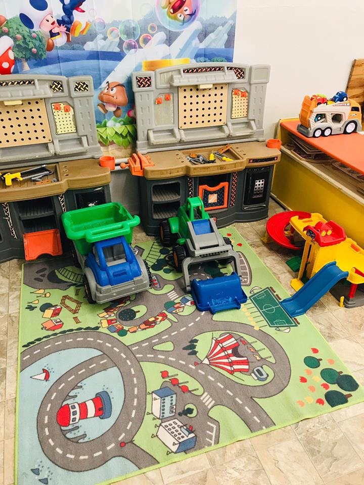 Toy workbench with toy trucks and cars on a road map playmat