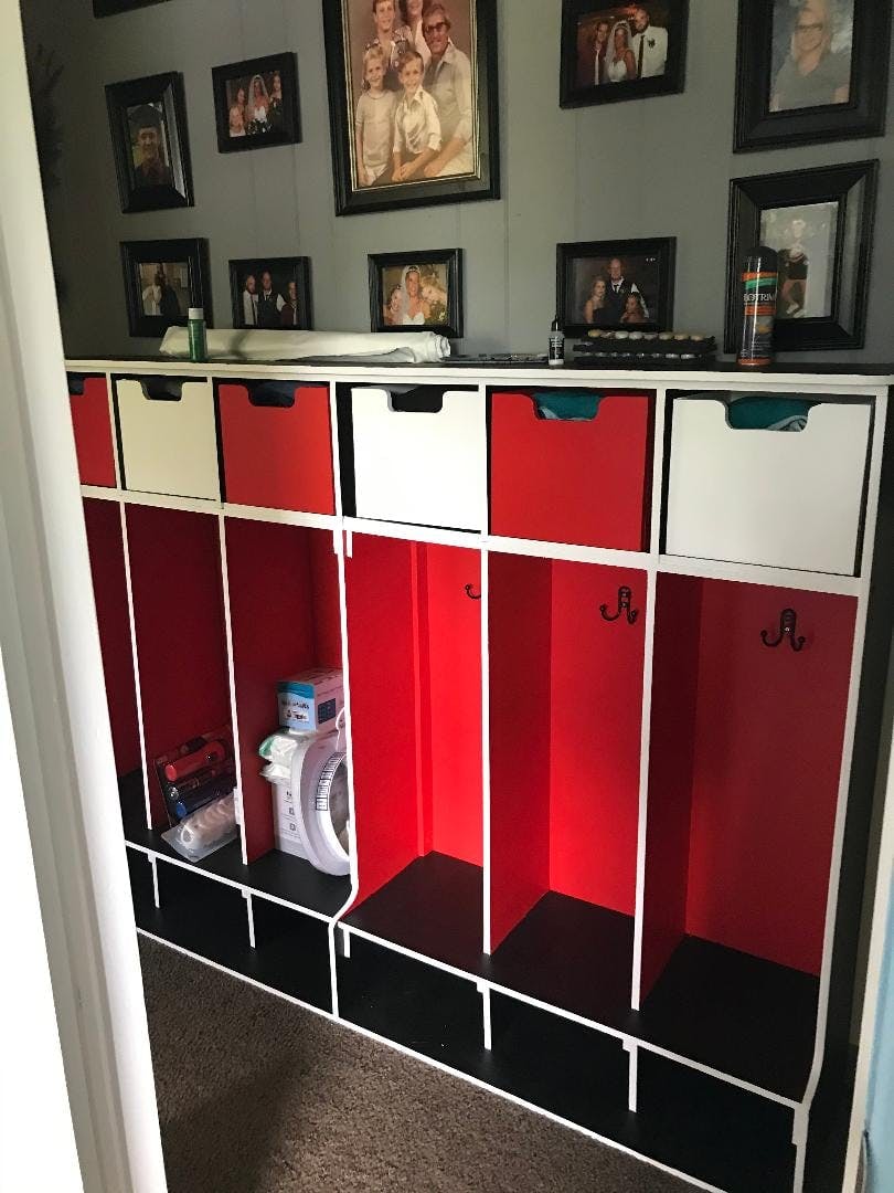 Red and white cubbies with drawers and hooks