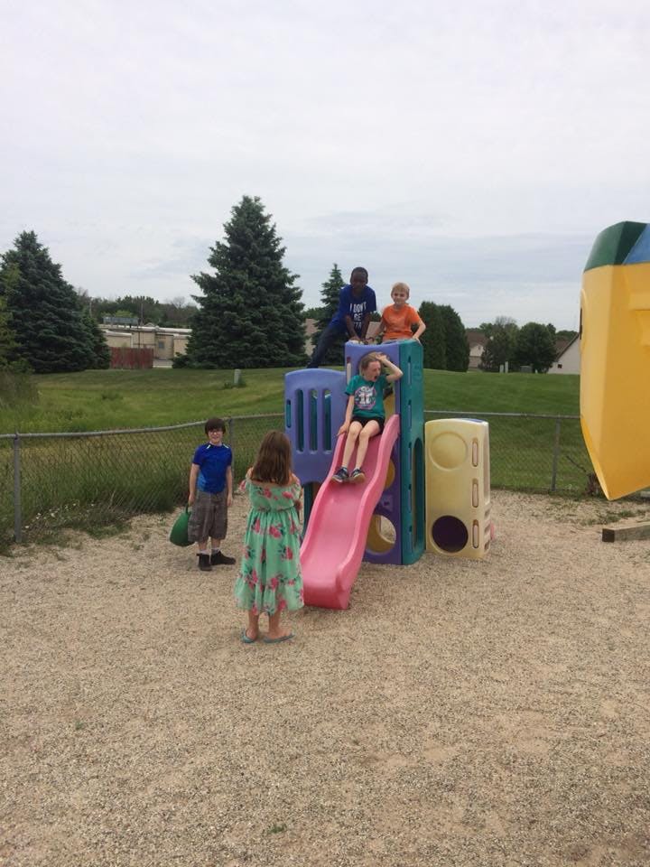 Children playing on a playground slide