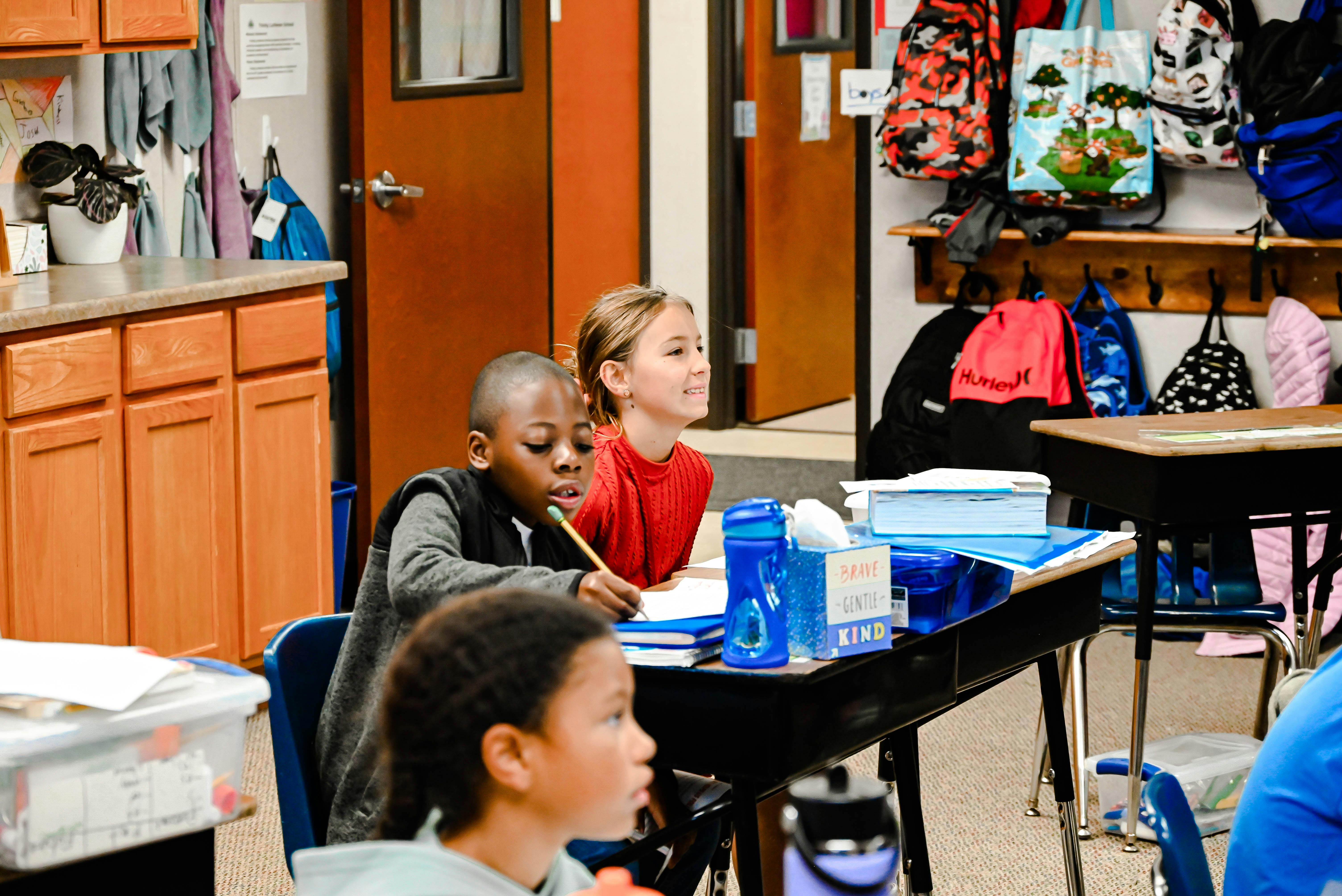 Children sitting at desks in a classroom
