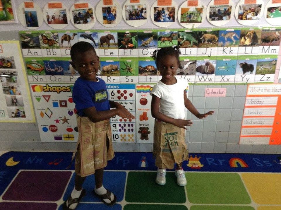 Two children standing in a classroom