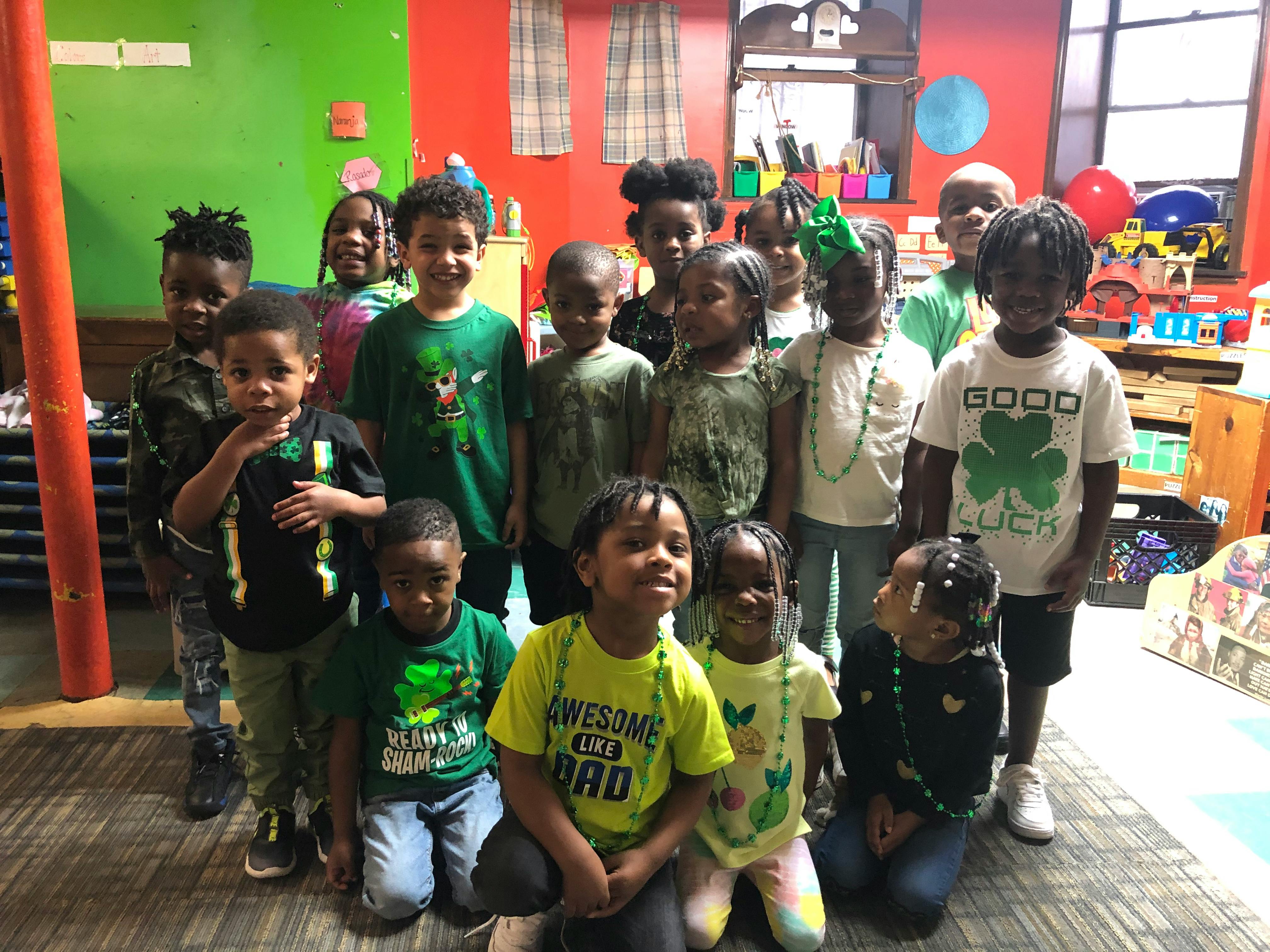 Group of children posing in a classroom