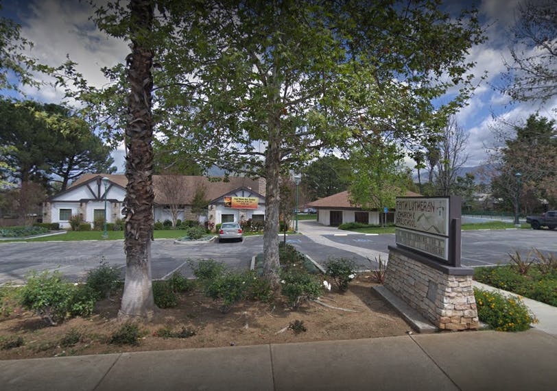 Building with a parking lot and trees in front