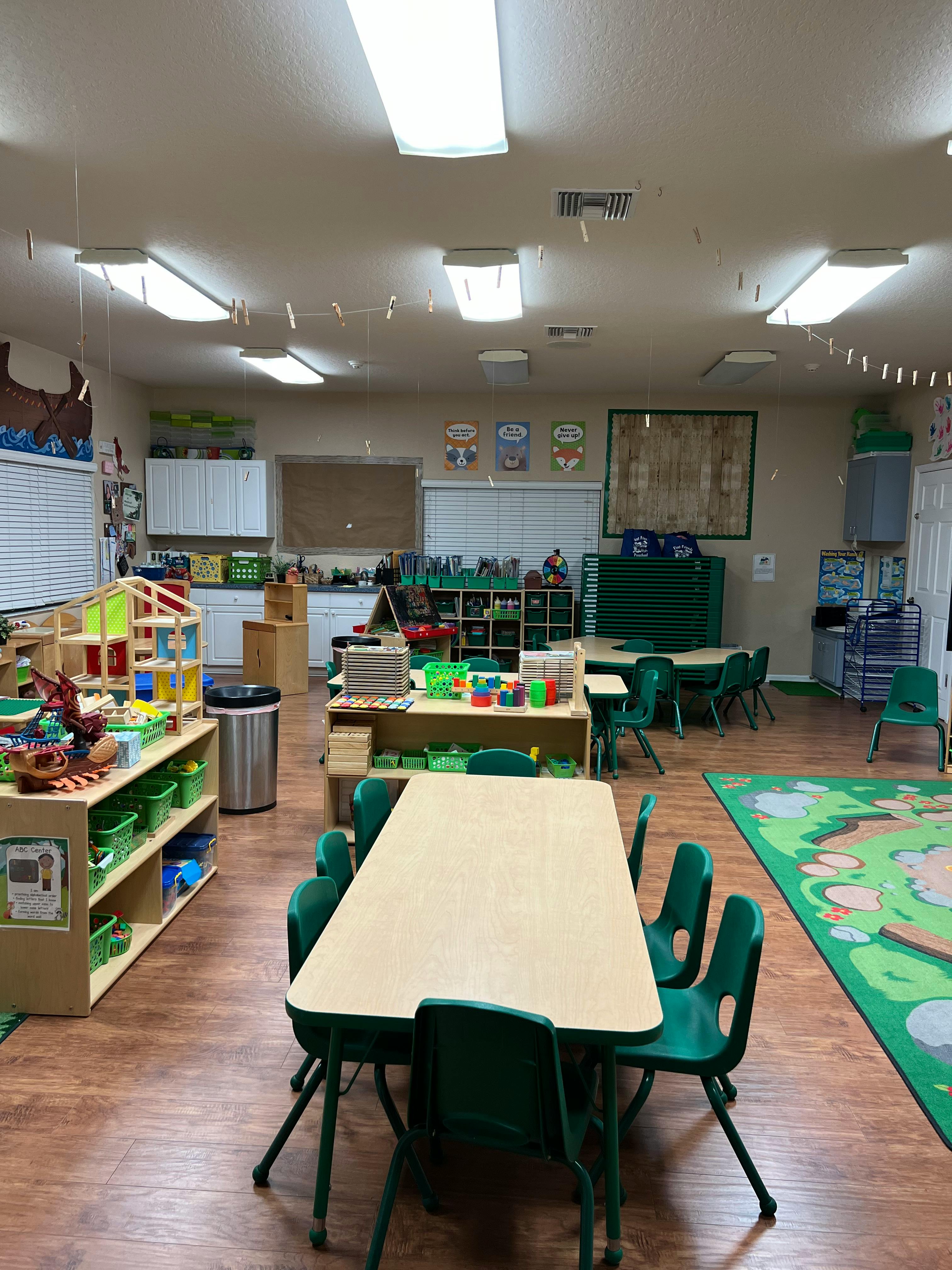Classroom with tables, chairs, and shelves