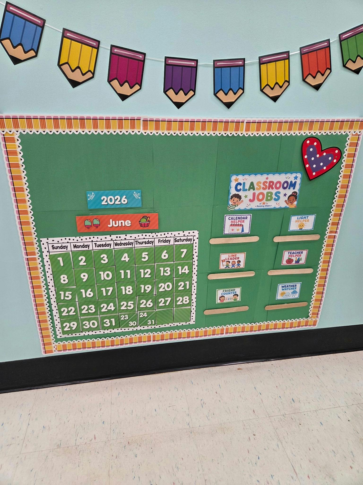 Classroom bulletin board with a June 2026 calendar and classroom jobs display