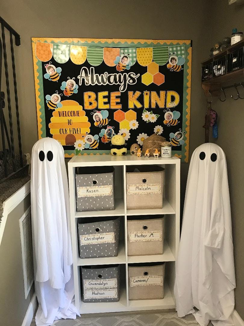 Two ghost figures flanking a white shelf unit with storage bins and a bulletin board
