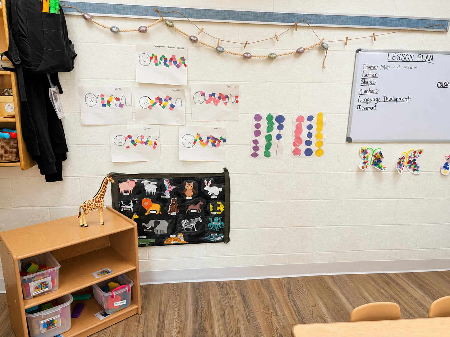 Classroom wall decorated with student art and an animal chart