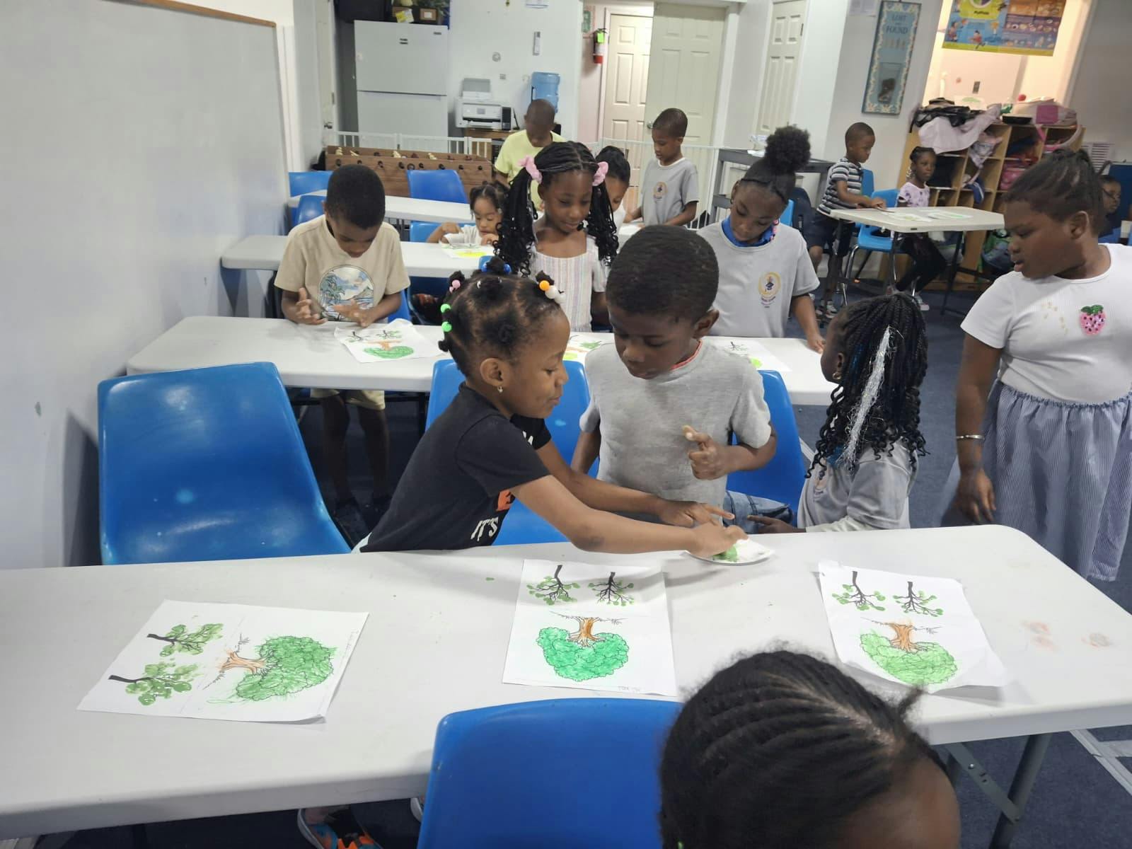Children sitting at tables, coloring and working on art projects