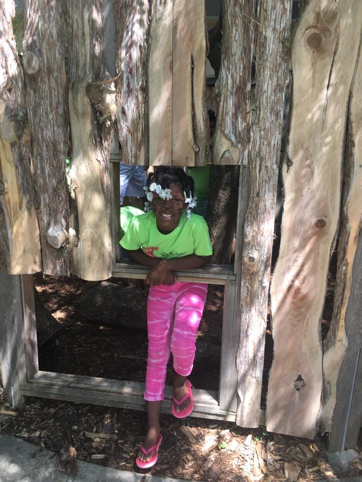 Child looking out of a wooden window