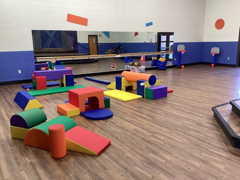 Colorful soft play equipment on a wooden floor