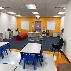 Empty classroom with small tables and chairs