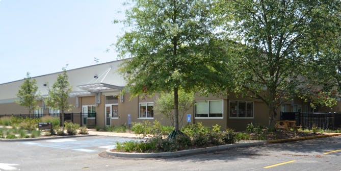 Exterior of a building with trees and a parking lot