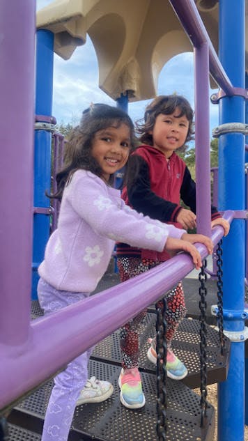 Two children on a playground structure