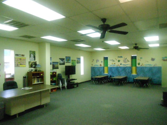 Classroom with tables, chairs, and ceiling fans