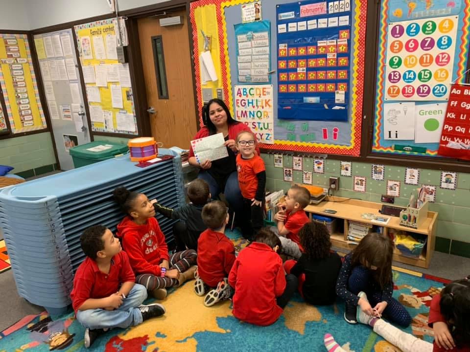 Person reading to children in a classroom