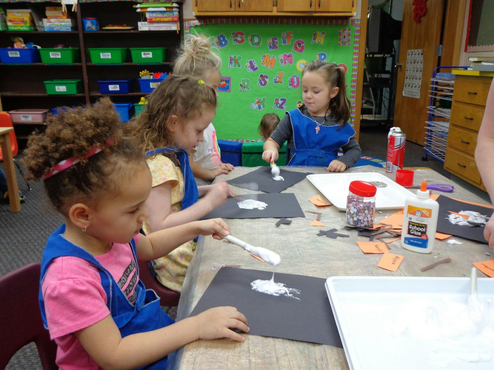 Children doing an art project at a table