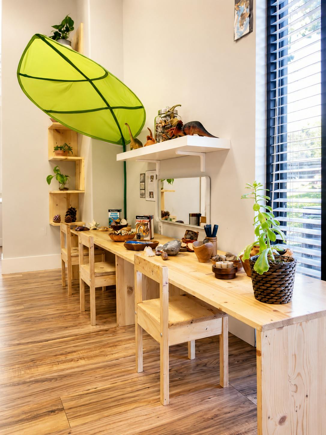 Wooden desk and chairs with nature-themed learning materials in a classroom