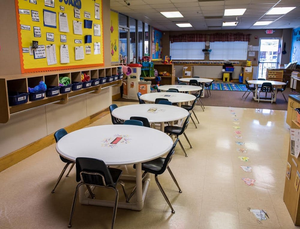 Empty classroom with round tables and chairs
