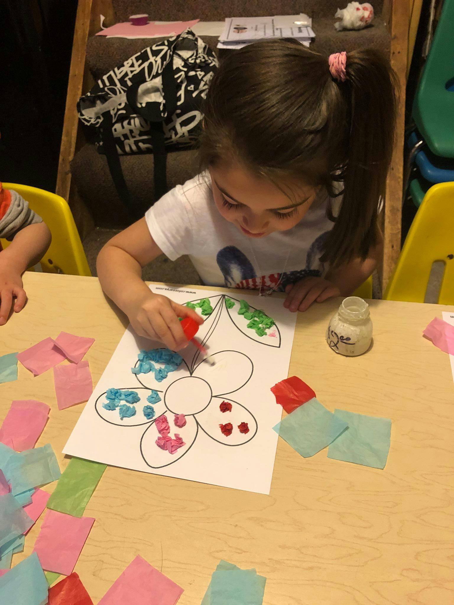Child doing a craft with paper and glue