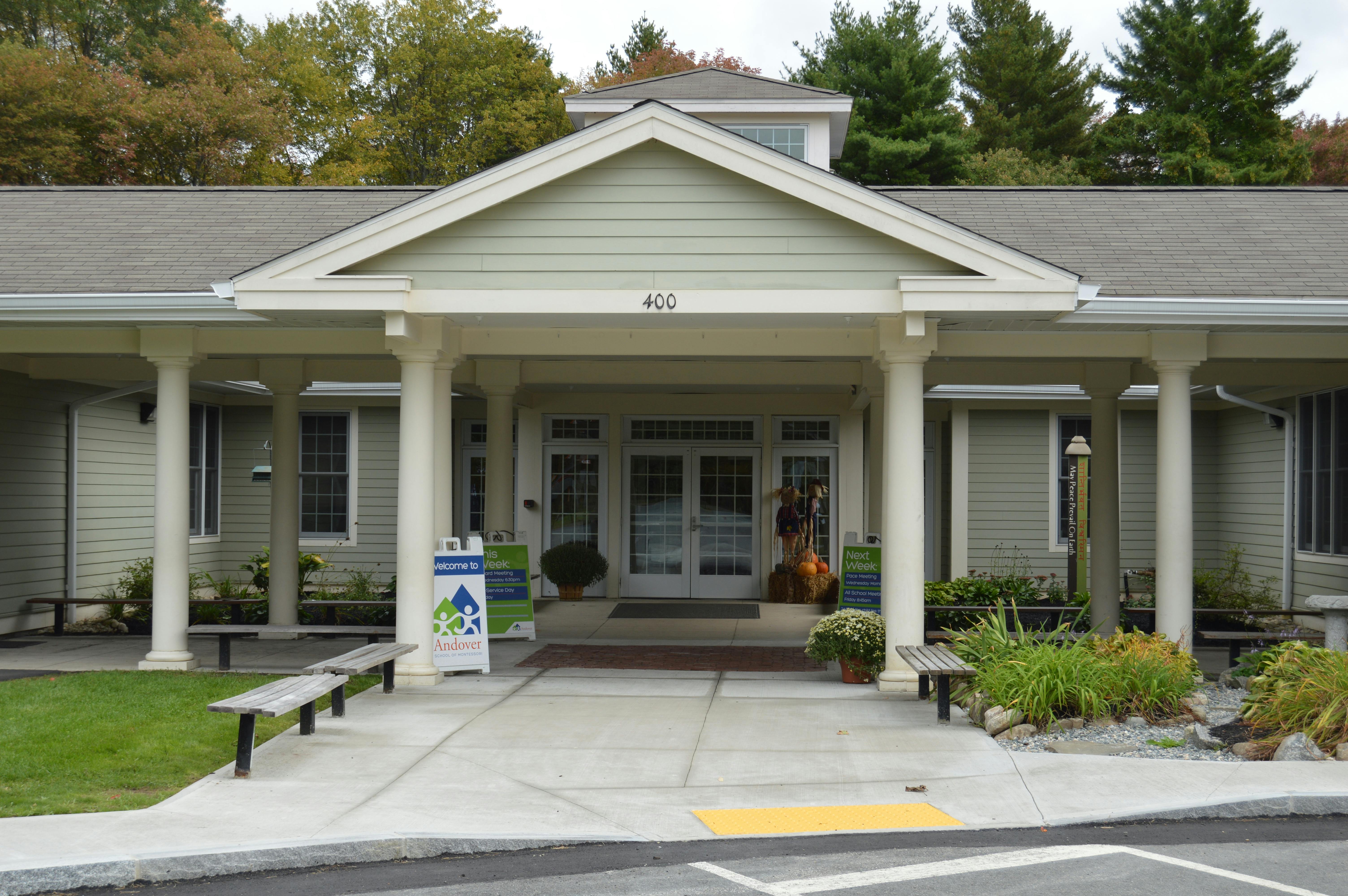 Front entrance of a building with a covered porch and columns