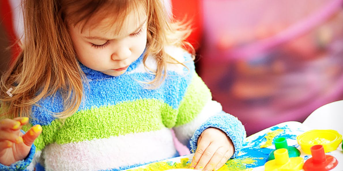 Child painting with fingers