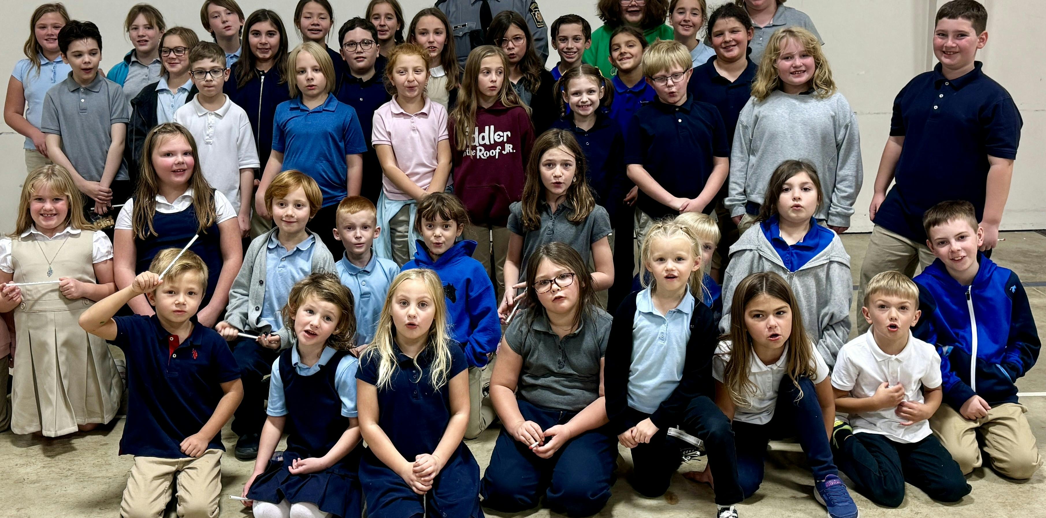 Group of children standing and kneeling for a photo