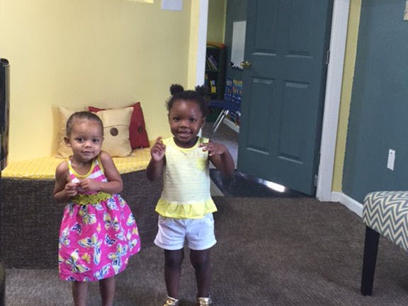 Two children standing indoors
