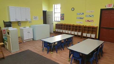Classroom with tables, chairs, and storage units