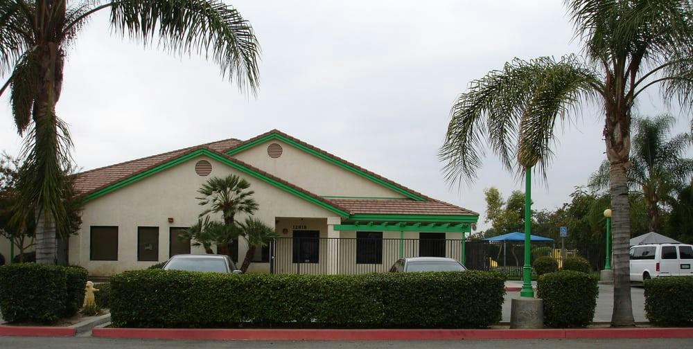 Building with green trim and palm trees
