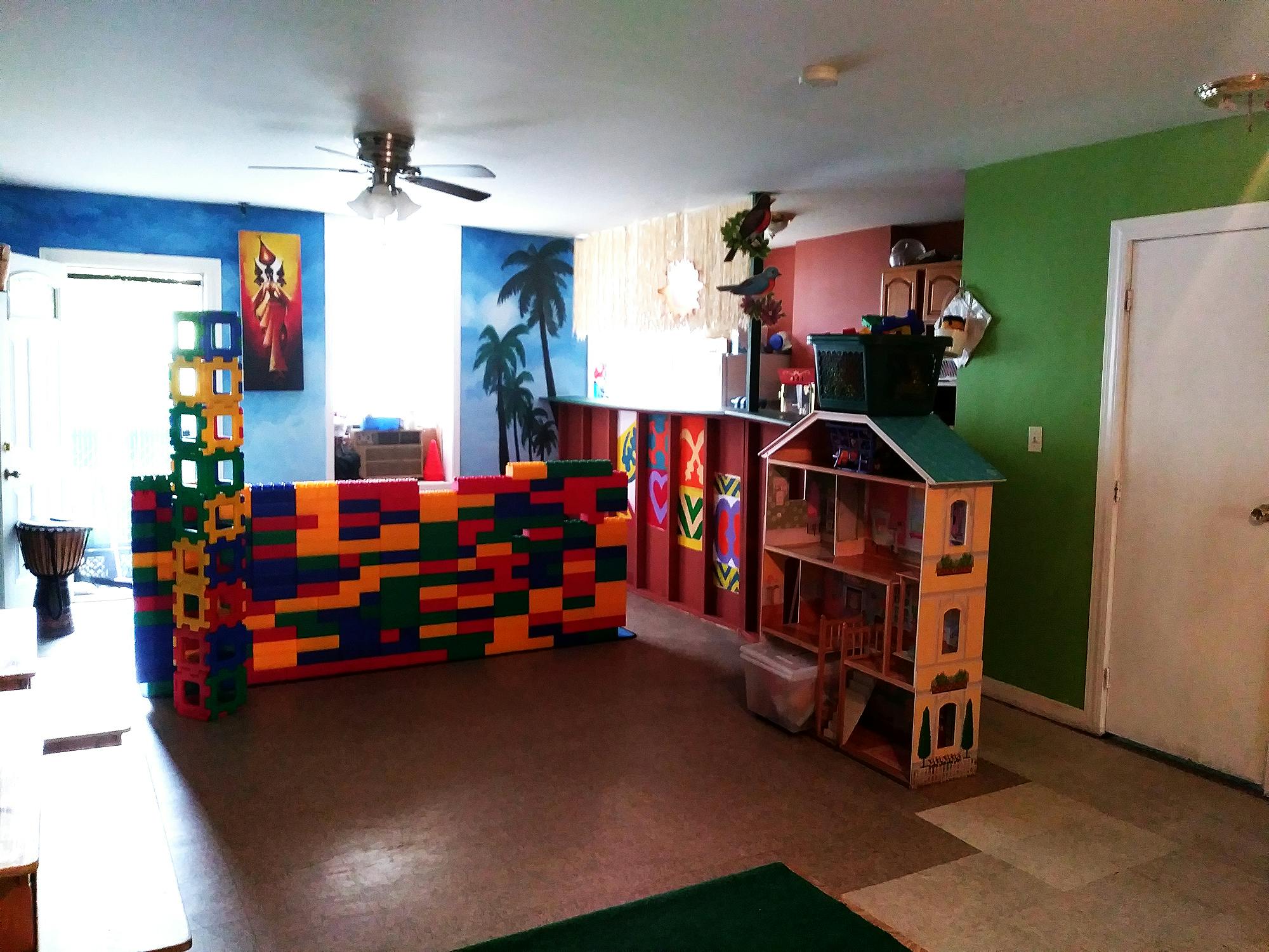 Playroom with colorful building blocks and a dollhouse