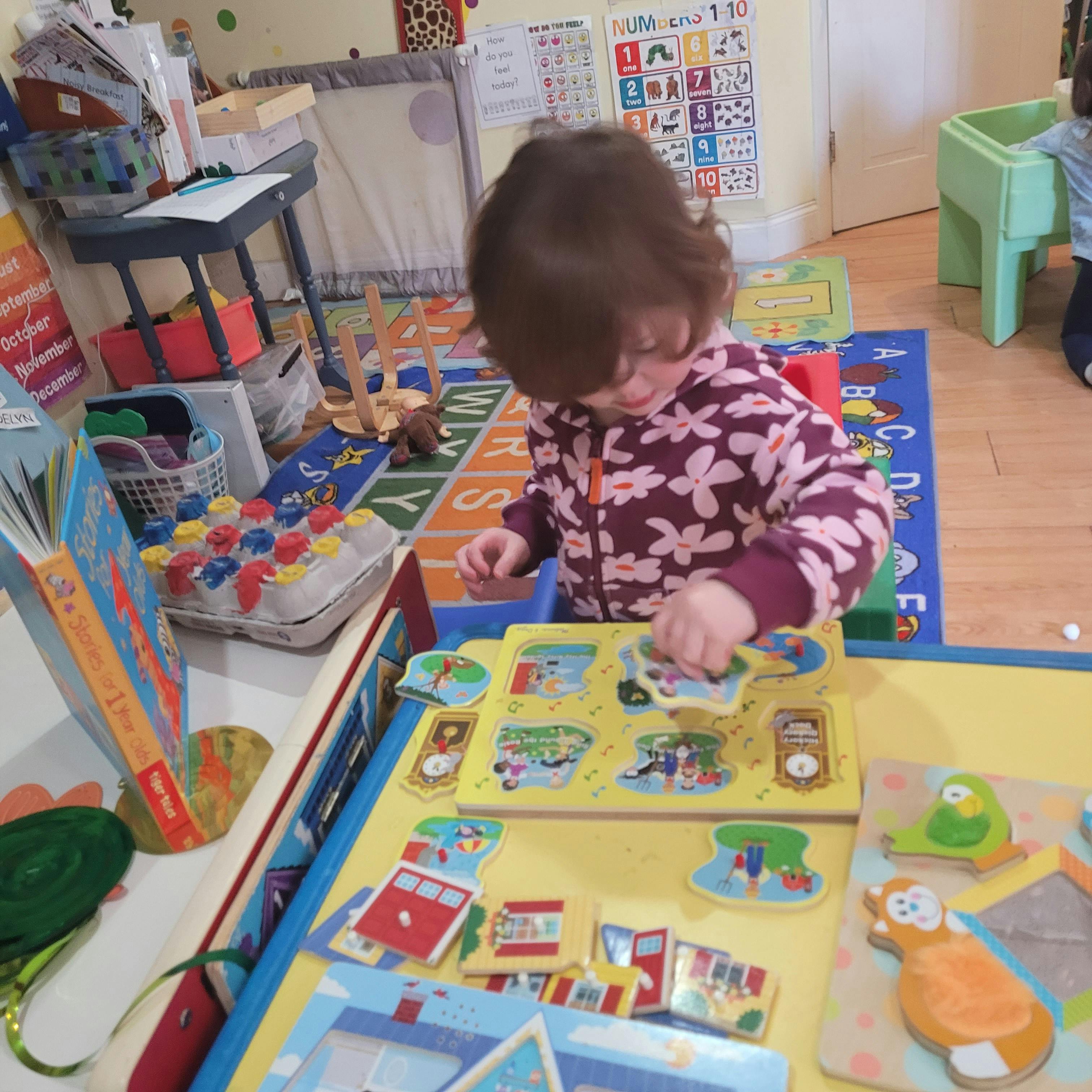 Child playing with a puzzle in a classroom
