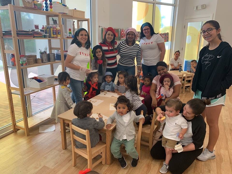 Adults and children gathered in a classroom