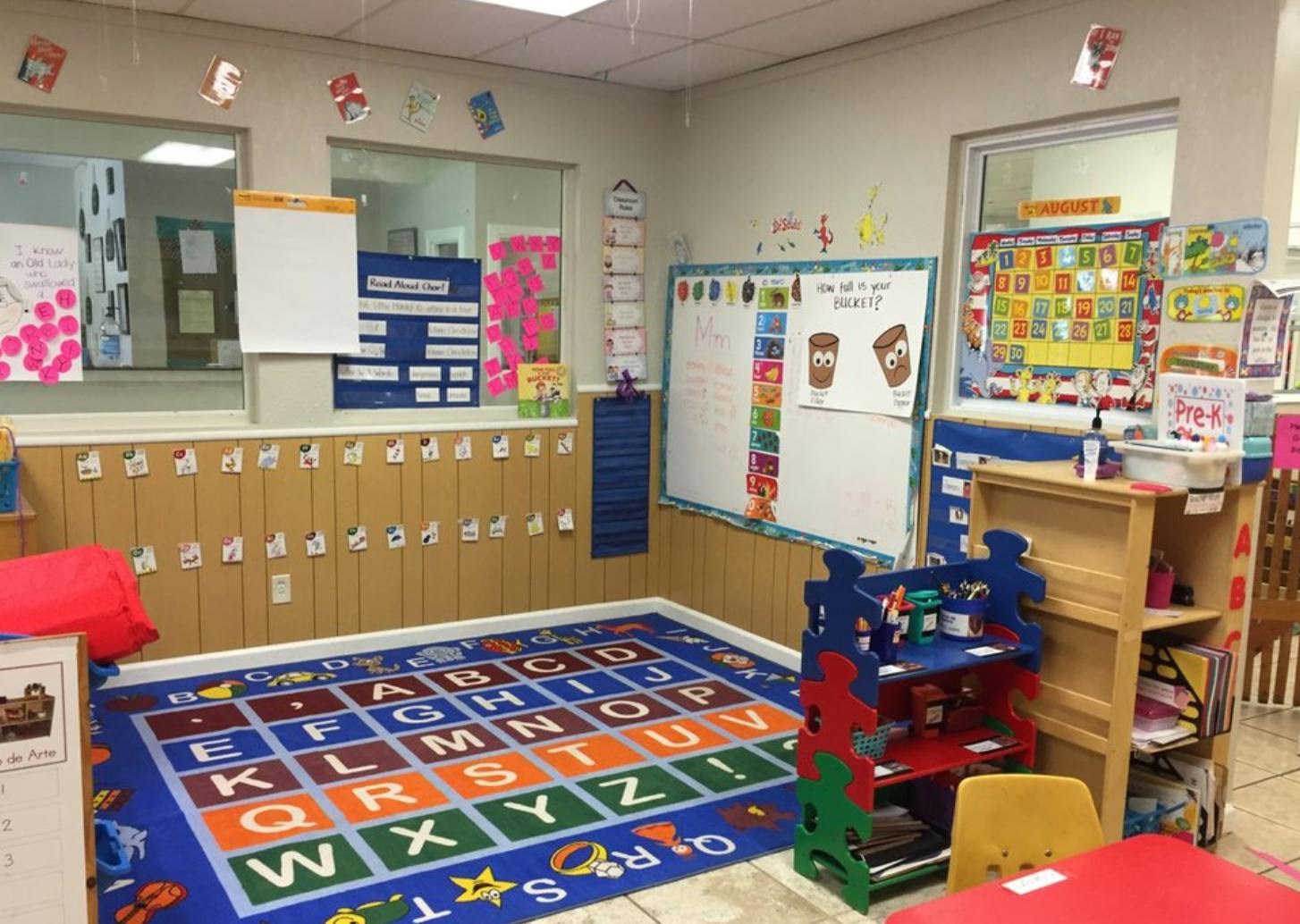 Classroom with an alphabet rug and learning materials on the walls