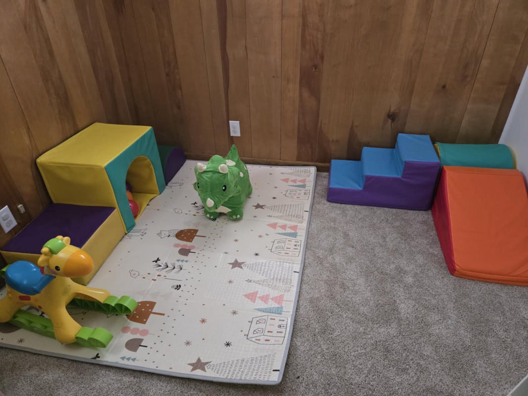 Playroom with soft play equipment and toys