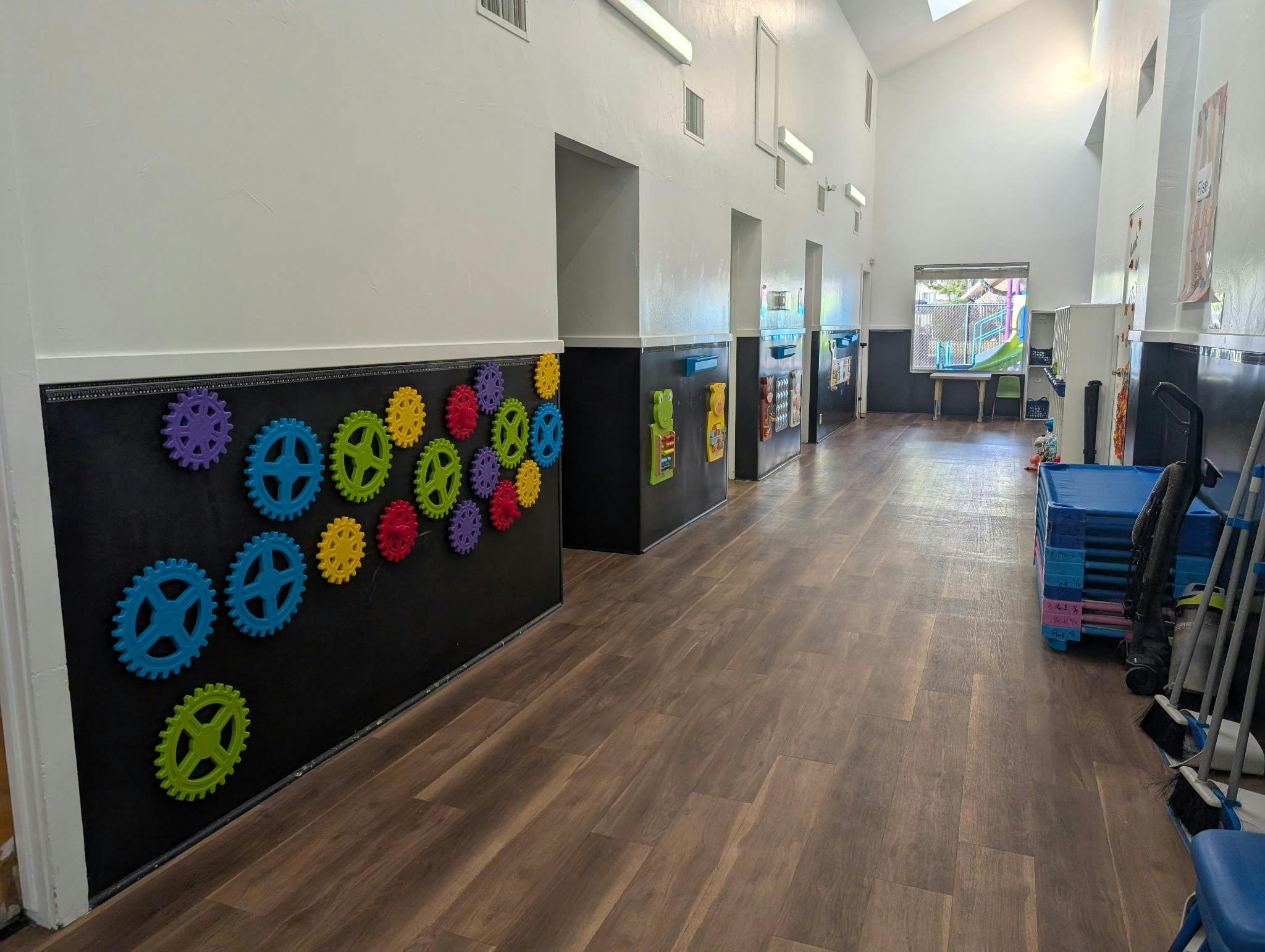 Hallway with colorful gears on a black wall