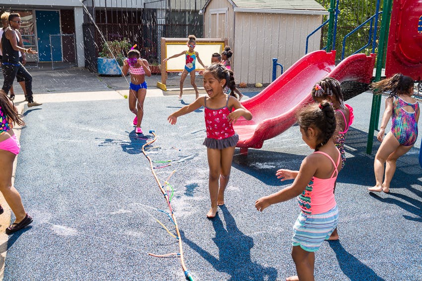 Children playing in water on a playground