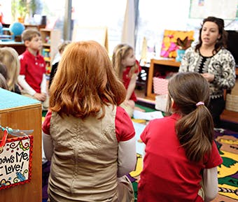 Adult speaking to children in a classroom