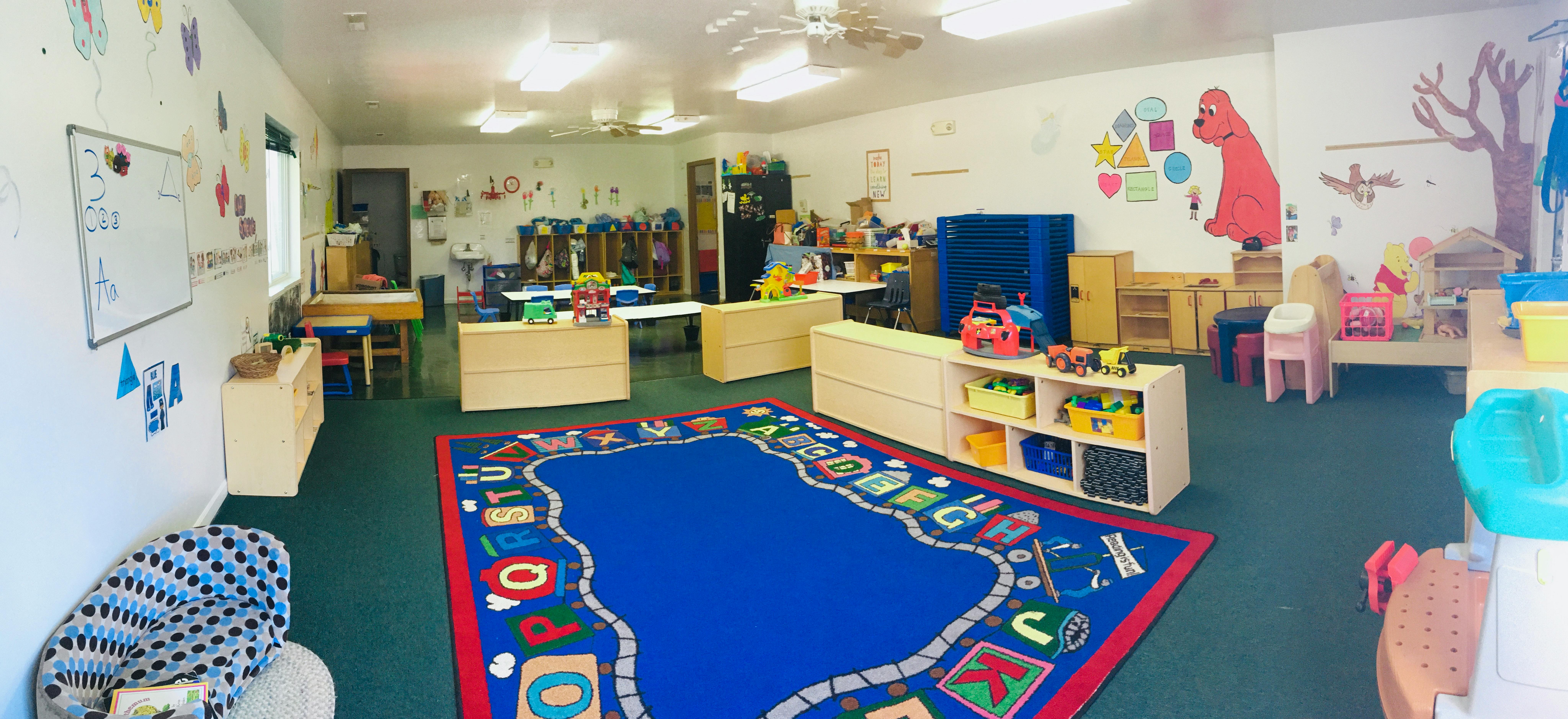 Classroom with toys and an alphabet rug