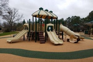 Playground structure with multiple slides and climbing areas