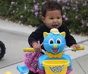 Child on a toy tricycle