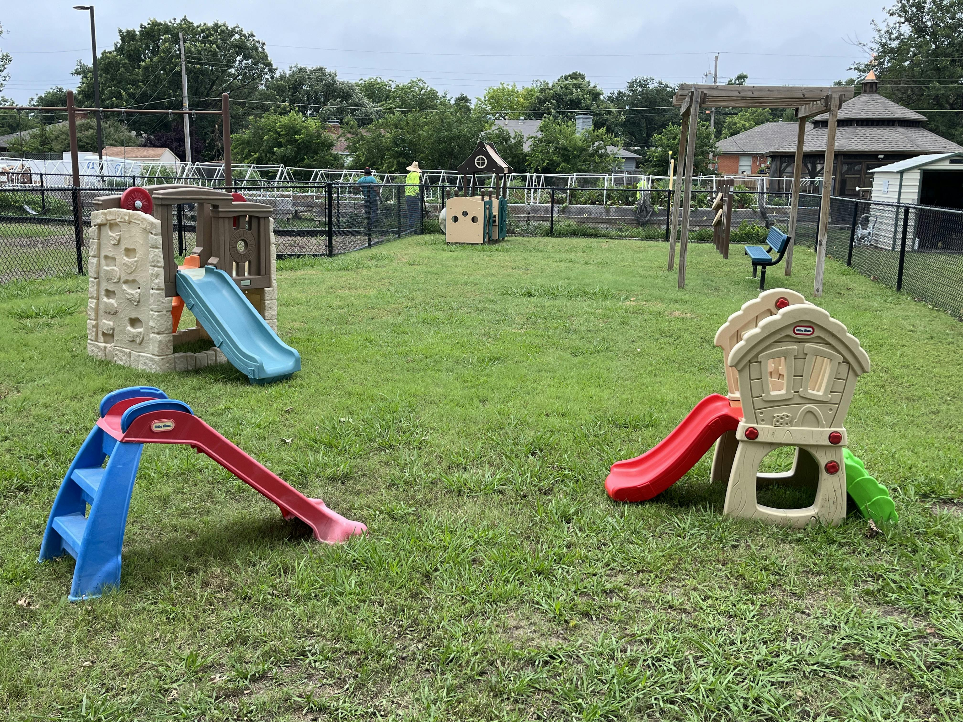 Playground with multiple slides and swings on grass