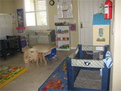 Playroom with small tables, chairs, and toys