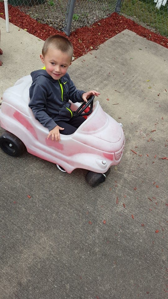Child in a toy car