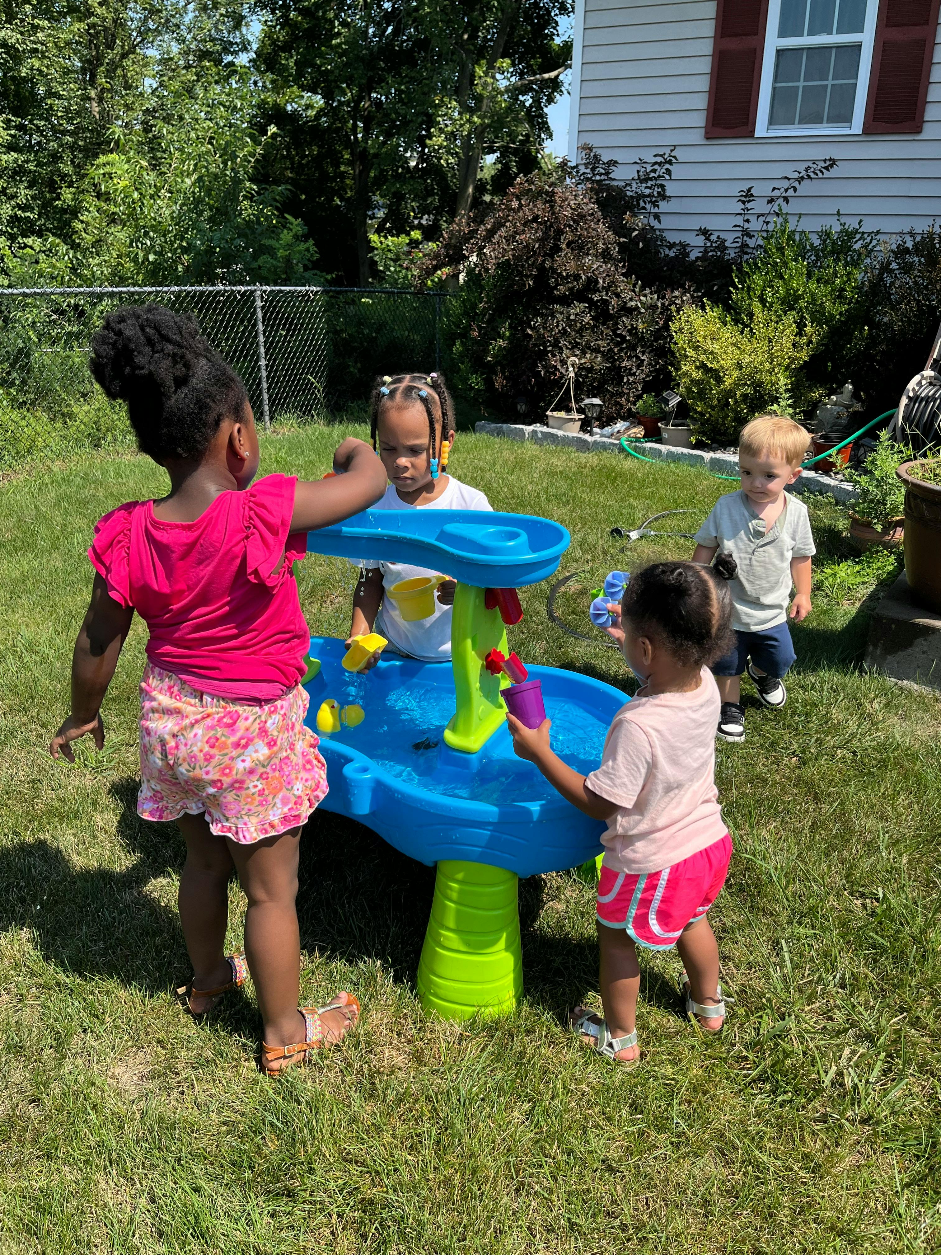 Children playing with a water table outdoors