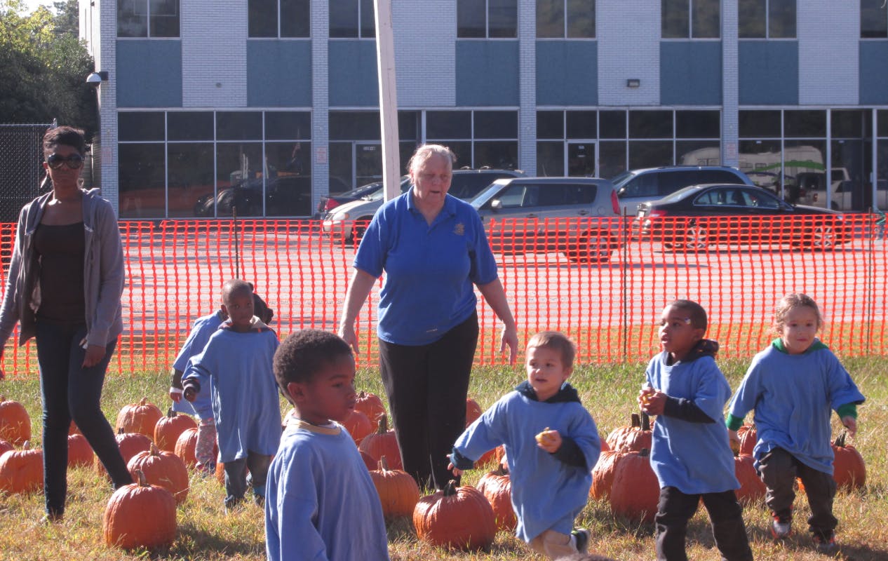 Adults and children in a pumpkin patch