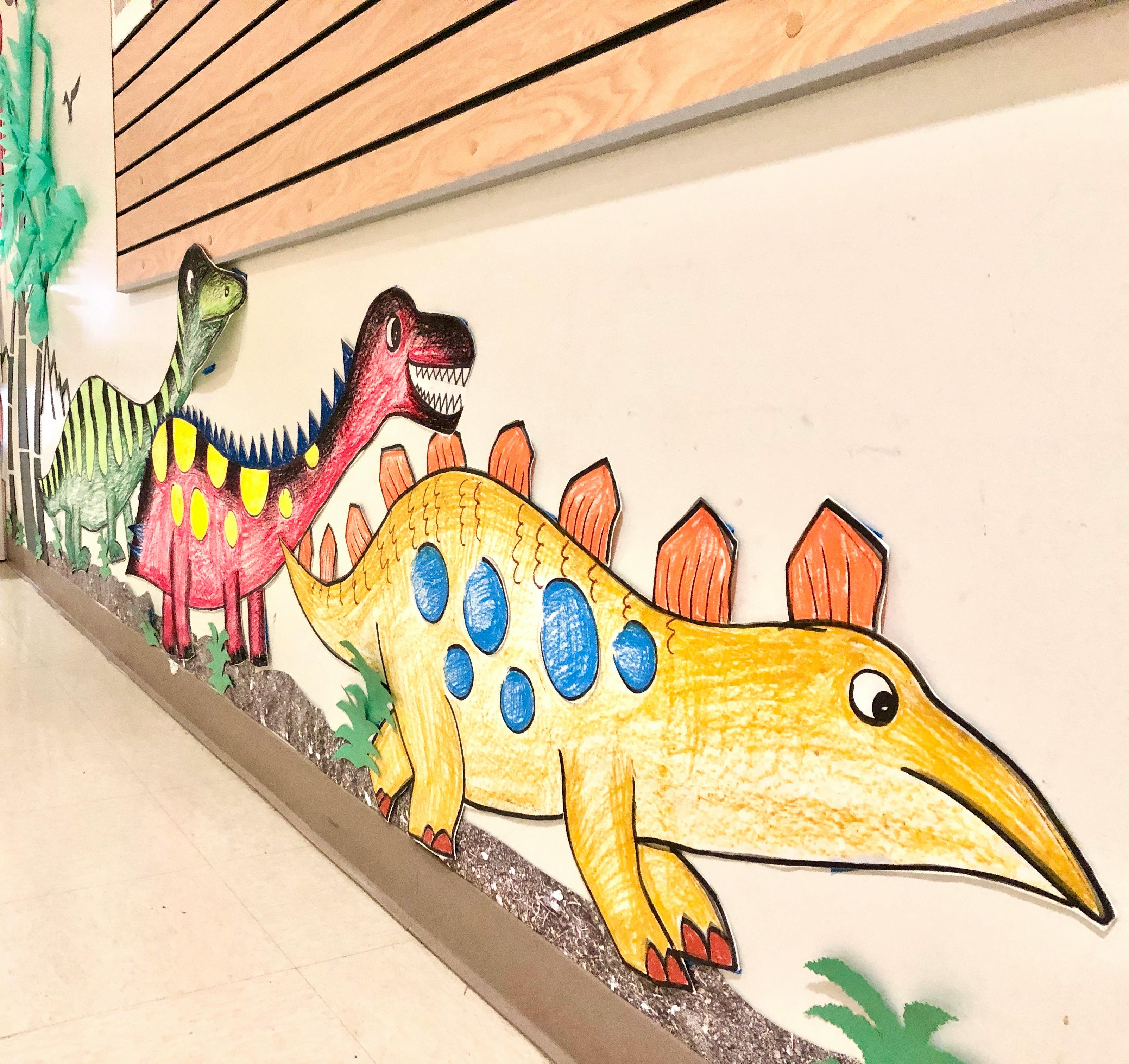 Dinosaur cutouts on a wall