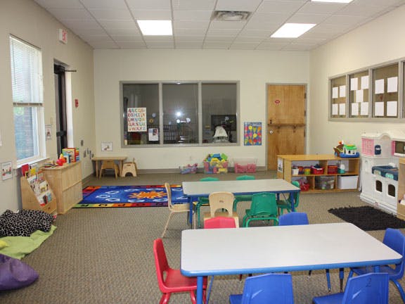 Empty classroom with small tables and chairs